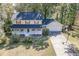 Traditional two-story home with a lovely front porch, attached garage, and a basketball hoop on the driveway at 4092 Deerbrook Sw Way, Lilburn, GA 30047