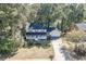 Classic two-story home with a front porch and two-car garage, situated among mature trees for privacy at 4092 Deerbrook Sw Way, Lilburn, GA 30047
