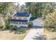 Charming two-story home boasts a welcoming front porch and attached two-car garage nestled in a wooded lot at 4092 Deerbrook Sw Way, Lilburn, GA 30047