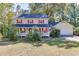 Charming two-story home with a welcoming front porch and beautiful landscaping at 4092 Deerbrook Sw Way, Lilburn, GA 30047
