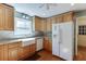 Well-lit kitchen with wood cabinets, granite countertops, and a modern farmhouse sink at 4092 Deerbrook Sw Way, Lilburn, GA 30047
