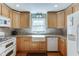 A brightly lit kitchen with stainless appliances, a farmhouse sink, and beautiful cabinetry at 4092 Deerbrook Sw Way, Lilburn, GA 30047