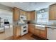 Bright kitchen featuring wooden cabinets, granite counters, and stainless steel appliances at 4092 Deerbrook Sw Way, Lilburn, GA 30047