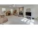 Bright living room featuring a stone fireplace, neutral carpet and a ceiling fan at 4092 Deerbrook Sw Way, Lilburn, GA 30047