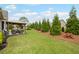 Expansive backyard with a patio, mature trees, and plenty of room for outdoor activities at 5775 Stellata Cir, Cumming, GA 30028
