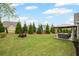 Lush backyard featuring a well-manicured lawn, mature trees, and a charming gazebo at 5775 Stellata Cir, Cumming, GA 30028
