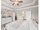 Bright bedroom featuring modern decor, a decorative accent sign, and a ceiling fan at 5775 Stellata Cir, Cumming, GA 30028