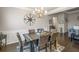 Inviting dining room with statement lighting and views to the living room at 5775 Stellata Cir, Cumming, GA 30028
