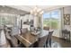 Elegant dining area featuring a modern chandelier and a view to the kitchen at 5775 Stellata Cir, Cumming, GA 30028