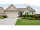 Charming home featuring a well-manicured lawn, a two-car garage, and an inviting entryway at 5775 Stellata Cir, Cumming, GA 30028