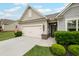 Charming home featuring a well-manicured lawn, a two-car garage, and an inviting entryway at 5775 Stellata Cir, Cumming, GA 30028
