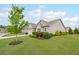 Charming home featuring a well-manicured lawn, an inviting entryway, and a beautiful tree at 5775 Stellata Cir, Cumming, GA 30028