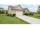 Well-manicured front yard with a two-car garage and charming exterior details at 5775 Stellata Cir, Cumming, GA 30028