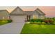 Charming home featuring a well-manicured lawn, a two-car garage, and an inviting entryway at 5775 Stellata Cir, Cumming, GA 30028