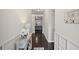 Hallway with decorative wainscoting, hardwood floors, and neutral paint at 5775 Stellata Cir, Cumming, GA 30028