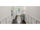 Hallway featuring decorative wainscoting, hardwood floors, and neutral paint at 5775 Stellata Cir, Cumming, GA 30028