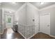Hallway featuring decorative wainscoting, hardwood floors, and neutral paint at 5775 Stellata Cir, Cumming, GA 30028