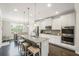 Modern kitchen with granite counters, stainless steel appliances, and an island with seating at 5775 Stellata Cir, Cumming, GA 30028
