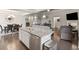 Open-concept kitchen featuring a granite island with bar seating and stainless appliances at 5775 Stellata Cir, Cumming, GA 30028