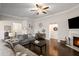 Spacious living room with a fireplace, ceiling fan, and comfortable gray sofa at 5775 Stellata Cir, Cumming, GA 30028