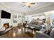 Bright living room featuring a fireplace, large windows, and hardwood floors at 5775 Stellata Cir, Cumming, GA 30028
