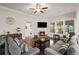 Cozy living room features a fireplace, hardwood floors, and a ceiling fan at 5775 Stellata Cir, Cumming, GA 30028