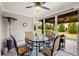 Covered outdoor patio featuring stylish seating and views of the landscaped backyard at 5775 Stellata Cir, Cumming, GA 30028