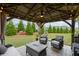 Inviting outdoor patio with a firepit, seating, and string lights for cozy evenings at 5775 Stellata Cir, Cumming, GA 30028