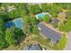 Aerial view showcasing community amenities including a pool, tennis courts, playground, and ample parking at 630 Silverberry Ln, Sugar Hill, GA 30518