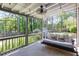 Idyllic covered back porch with a swing and views of the spacious, tree-lined backyard, perfect for relaxation at 630 Silverberry Ln, Sugar Hill, GA 30518