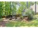 Private backyard oasis featuring a fire pit, seating area, hammock, and a storage shed, perfect for outdoor enjoyment at 630 Silverberry Ln, Sugar Hill, GA 30518