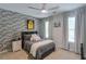 Cozy bedroom with brick accent wall, window, and comfortable furnishings, perfect for relaxation at 630 Silverberry Ln, Sugar Hill, GA 30518