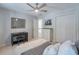 This bedroom features neutral paint, a ceiling fan, and a desk, providing a comfortable and functional space at 630 Silverberry Ln, Sugar Hill, GA 30518