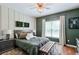 Comfortable bedroom with unique wall decor, hardwood floors and bench at 630 Silverberry Ln, Sugar Hill, GA 30518