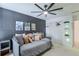 This bedroom features geometric accent wall, modern ceiling fan, and closet at 630 Silverberry Ln, Sugar Hill, GA 30518