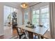 Bright dining area featuring a rustic wooden table and views to a comfortable living room at 630 Silverberry Ln, Sugar Hill, GA 30518