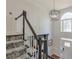 A foyer featuring a staircase with modern railings and a statement chandelier, creating an inviting entrance at 630 Silverberry Ln, Sugar Hill, GA 30518