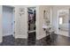 Hallway with tile floors, leading to a walk-in closet, make-up vanity, and a bedroom at 630 Silverberry Ln, Sugar Hill, GA 30518