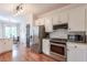 Well-lit kitchen with stainless steel appliances, white cabinets, and subway tile backsplash at 630 Silverberry Ln, Sugar Hill, GA 30518
