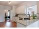 Bright kitchen featuring granite countertops, white cabinets and stainless steel appliances at 630 Silverberry Ln, Sugar Hill, GA 30518