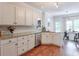 Spacious kitchen featuring white cabinets, granite countertops, and stainless steel appliances at 630 Silverberry Ln, Sugar Hill, GA 30518
