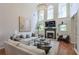 Spacious living room with a fireplace, large windows, and stylish decor for a cozy ambiance at 630 Silverberry Ln, Sugar Hill, GA 30518
