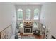 High-ceiling living room with fireplace, large windows, modern chandelier, and cozy seating area at 630 Silverberry Ln, Sugar Hill, GA 30518