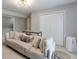 This living room features neutral decor, a sofa with plush pillows, and bright lighting at 630 Silverberry Ln, Sugar Hill, GA 30518