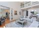 Bright, open living room with hardwood floors and views into the adjacent breakfast area at 630 Silverberry Ln, Sugar Hill, GA 30518