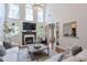 Open-concept living room with tall ceilings, fireplace, and ample natural light creating a bright space at 630 Silverberry Ln, Sugar Hill, GA 30518
