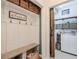 Mudroom with built-in bench, storage baskets, and access to the laundry room at 630 Silverberry Ln, Sugar Hill, GA 30518