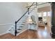 Elegant staircase with dark wood accents and carpet runner leads to the upper level at 630 Silverberry Ln, Sugar Hill, GA 30518