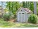 Charming storage shed with classic details in the backyard, providing functional and stylish outdoor storage solutions at 630 Silverberry Ln, Sugar Hill, GA 30518