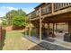 Multi-level backyard with a patio, landscaped area, and stairs leading to an elevated screened porch at 1212 Overlook Lake Dr, Dacula, GA 30019